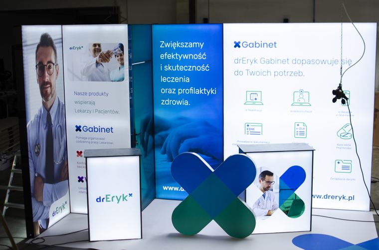 Stoisko dr Eryk z ladą i przestrzennym logo, złożone w hali
