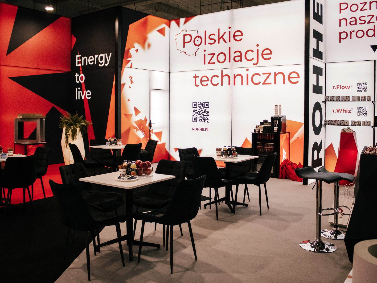 Strefa spotkań na stoisku ROHHE na HVAC Expo: stoliki, hokery, ściana Polskie izolacje techniczne